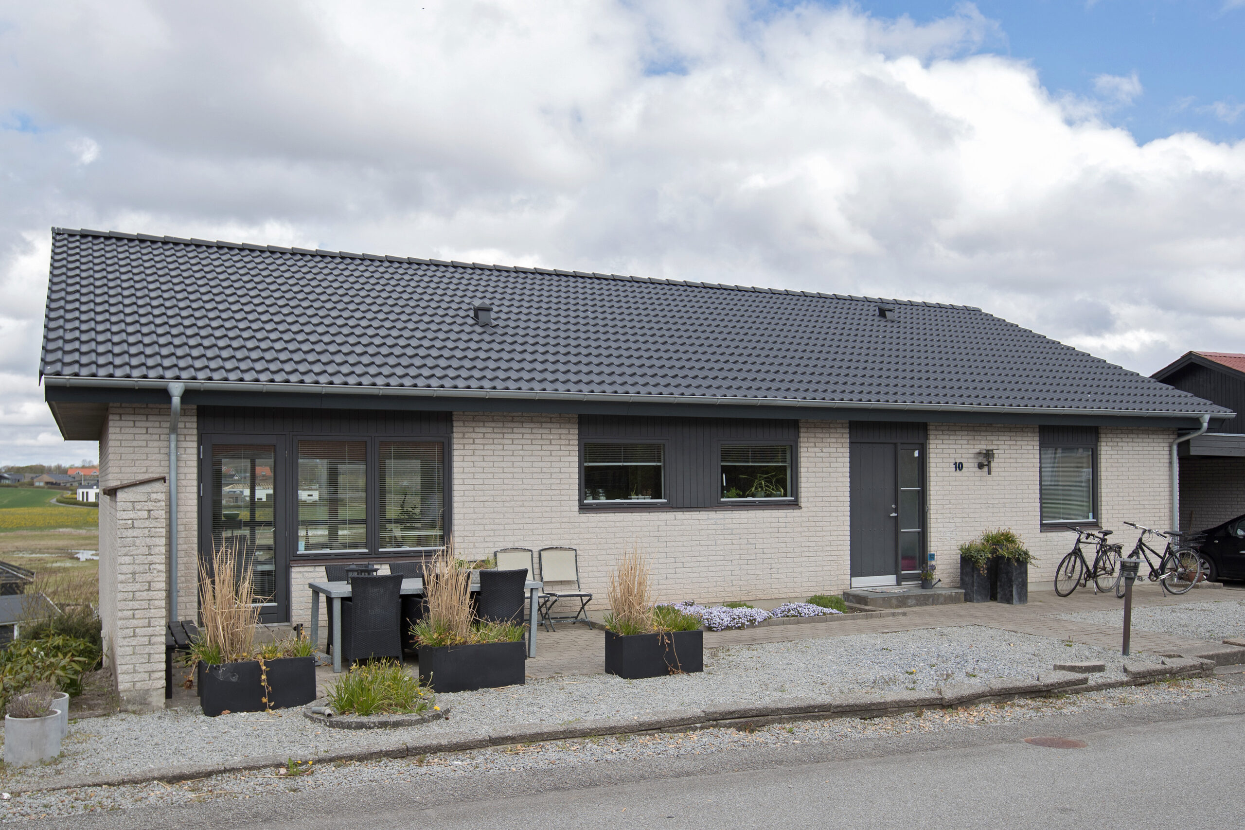 Moderne etplans murstenshus med mørkt tegltag