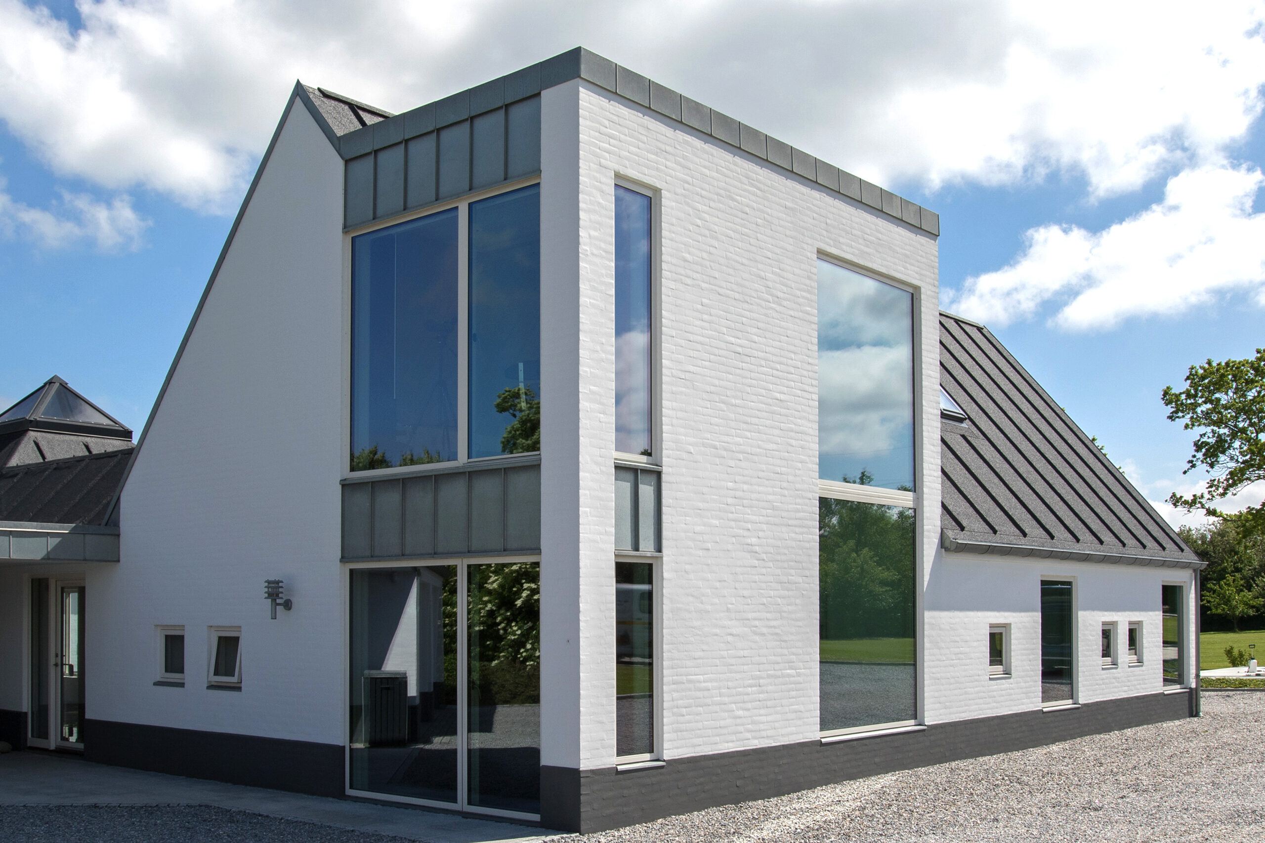 Moderne hvidt murstenshus med store vinduer