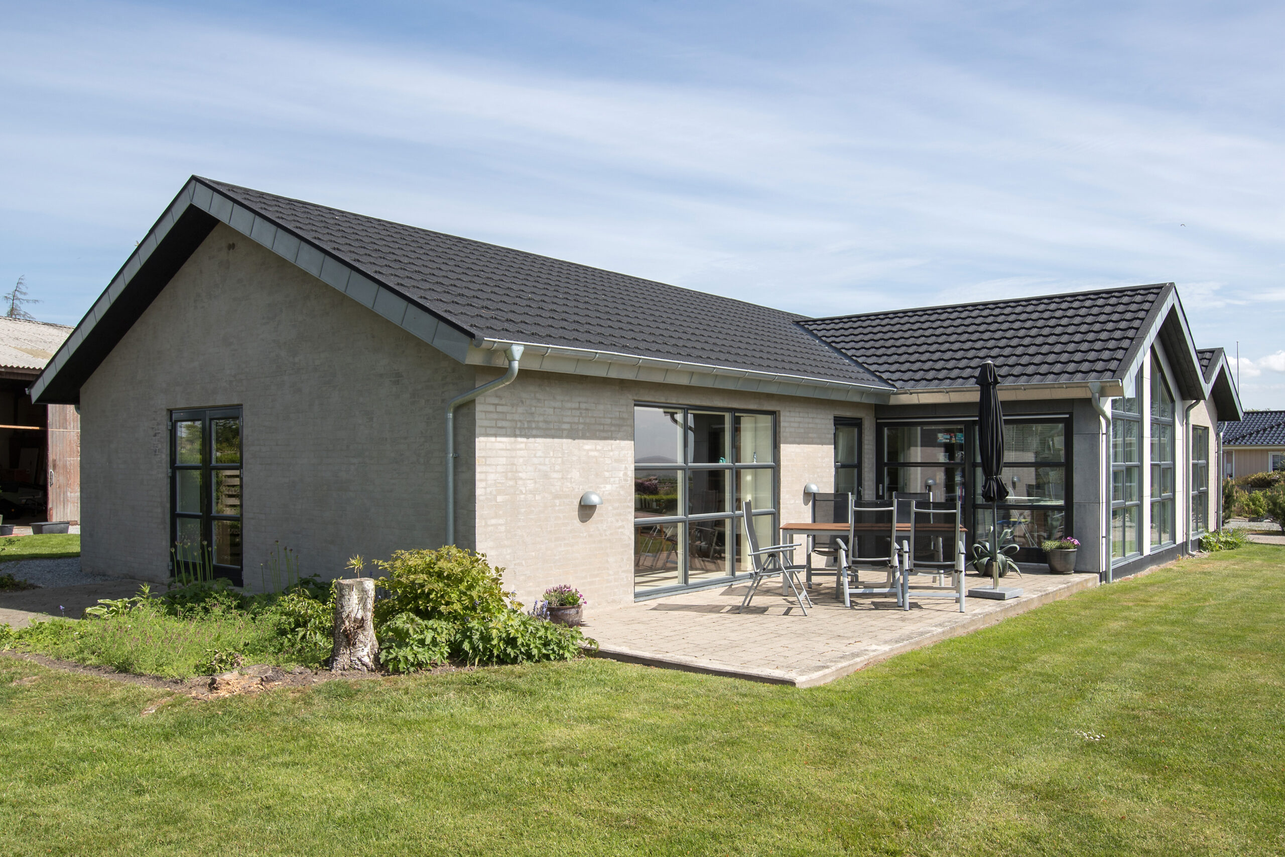 Moderne murstenshus med terrasse og stor have